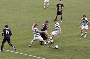 J.T. Noone splits two defenders against Celtic. (Photo: Paul Rudderow)