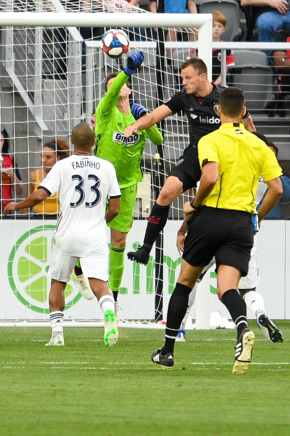 Matt Freese (1) punches out the PK kick from Wayne Rooney