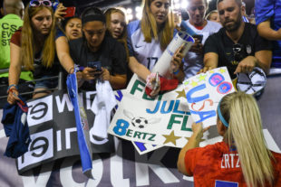 Julie Ertz takes time so sign autograghs and thank fans for coming to the game to support them.