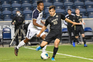 OSCAR PEREIRA from Army, works on a pass before Navy's Diego Manrique puts too much pressure on him.