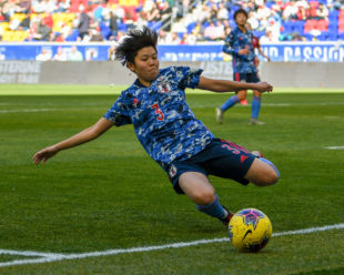 Shiori Miyake from Japan tries to save the ball from going out of bounds with a slide tackle.