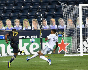 Donovan Pines, DC United, attempts to stop Sergio Santos, Philadelphia Union, shot on goal. Sergio scores!