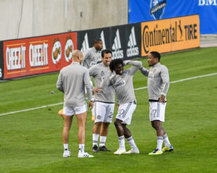 During pre-game warm-ups, Sergio Santos has some fun with Michee Ngalina. Ilsinho and Collin look on and laugh.