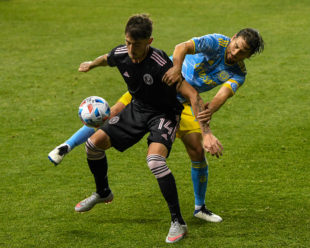 Alejandro Bedoya works to get his foot on the ball while defending Jay Chapman.
