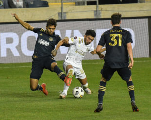 Matt Real and Marcelino Moreno fight for the ball during the second half of the game.