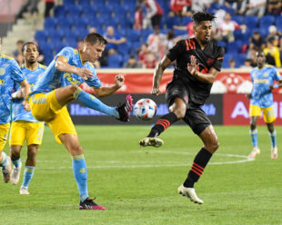 Jack Elliot boots the ball as Fábio Roberto Gomes Netto tried to defend him.