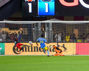 Andre Blake tries to stop a flying goal by   Yordy Reyna. Alvas Powell was there to help defend the net but was not able to stop the goal.