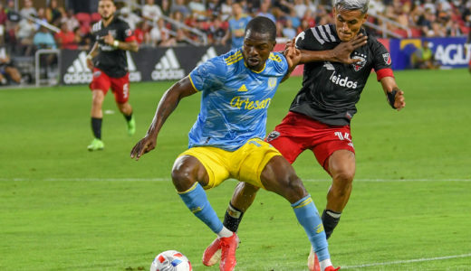 Corey Burke uses his hands and body to shield the ball from Andy Najar just outside D.C. United's box.