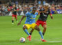 Corey Burke uses his hands and body to shield the ball from Andy Najar just outside D.C. United's box.