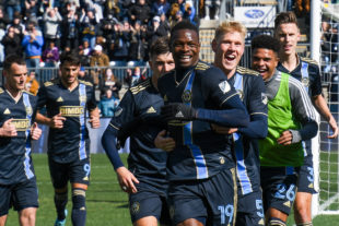 Cory Burke celebrates with his teammates after scoring the first goal of the 2022 season. Jakob Glesnes registers his first assist during the same play.