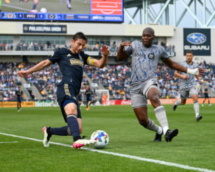 Under pressure from Kamal Miller, Alejandro Bedoya keeps the ball in play with a quick touch.