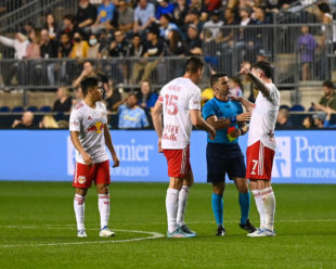 Thomas Edwards talks with referee, Rubiel Vazquez, about the yellow card that will be issued to Dylan Nealis giving him a red card due to accumulation.
