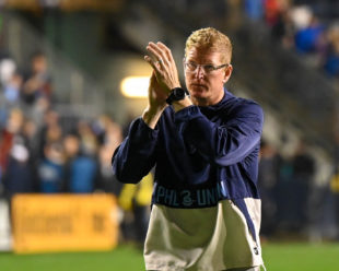 Jim Curtin salutes the crowd as he leaves the field at the end of the game.