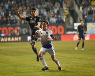 Leon Flach challenges for the ball while Mauricio Pereyra brings the ball under control.