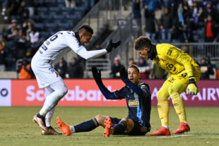 After a hard tackle, Daniel Gazdag gets yelled at by Henry Romero and Mario González who were both involved in the play.