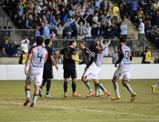 After making the PK, Daniel Gazdag runs over to celebrate in front of Atlas players.