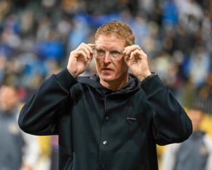 Jim curtin takes the field and prepares for the start of the game.
