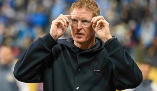 Jim curtin takes the field and prepares for the start of the game.