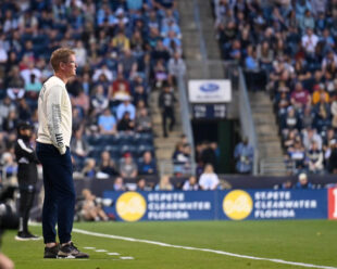 Jim Curtin watches him team take the field in the first half of the game.