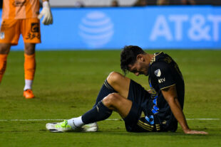 Clearly in pain, Julián Carranza goes down in the 81st minute holding the back of his leg.