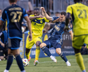 Philadelphia Union's Daniel Gazdag lunges for a tackle against Shaquell Moore of Nashville SC.