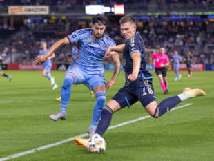 Philadelphia Union's forward 
Mikael Uhre kicks the ball while New York City FC's forward Mounsef Bakrar tries to stop him.