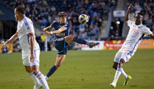 Quinn Sullivan kicks the ball as Obinna Nwobodo attempts to block him.