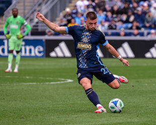 A classic image of Kia Wagner crossing a ball into the box.