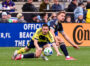 Bruno Damiani gets his foot on the ball before taking Alex Muyl down outside the box.